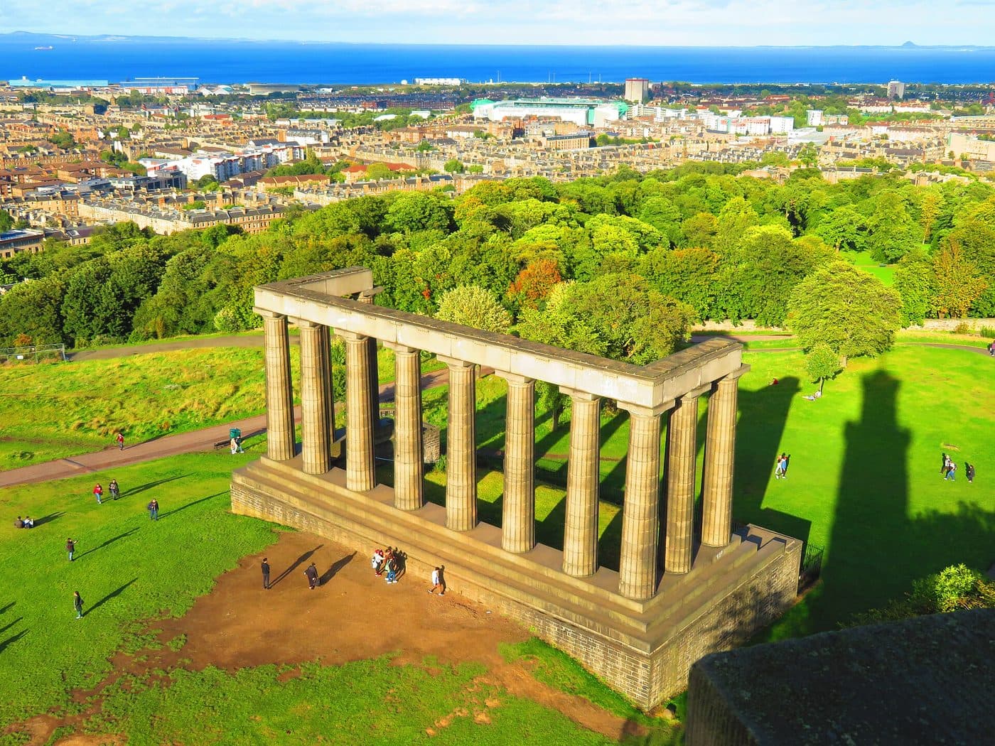 The twelve columns of the National Monument on Calton Hill seen from above, with the New Town and the Firth of Forth behind