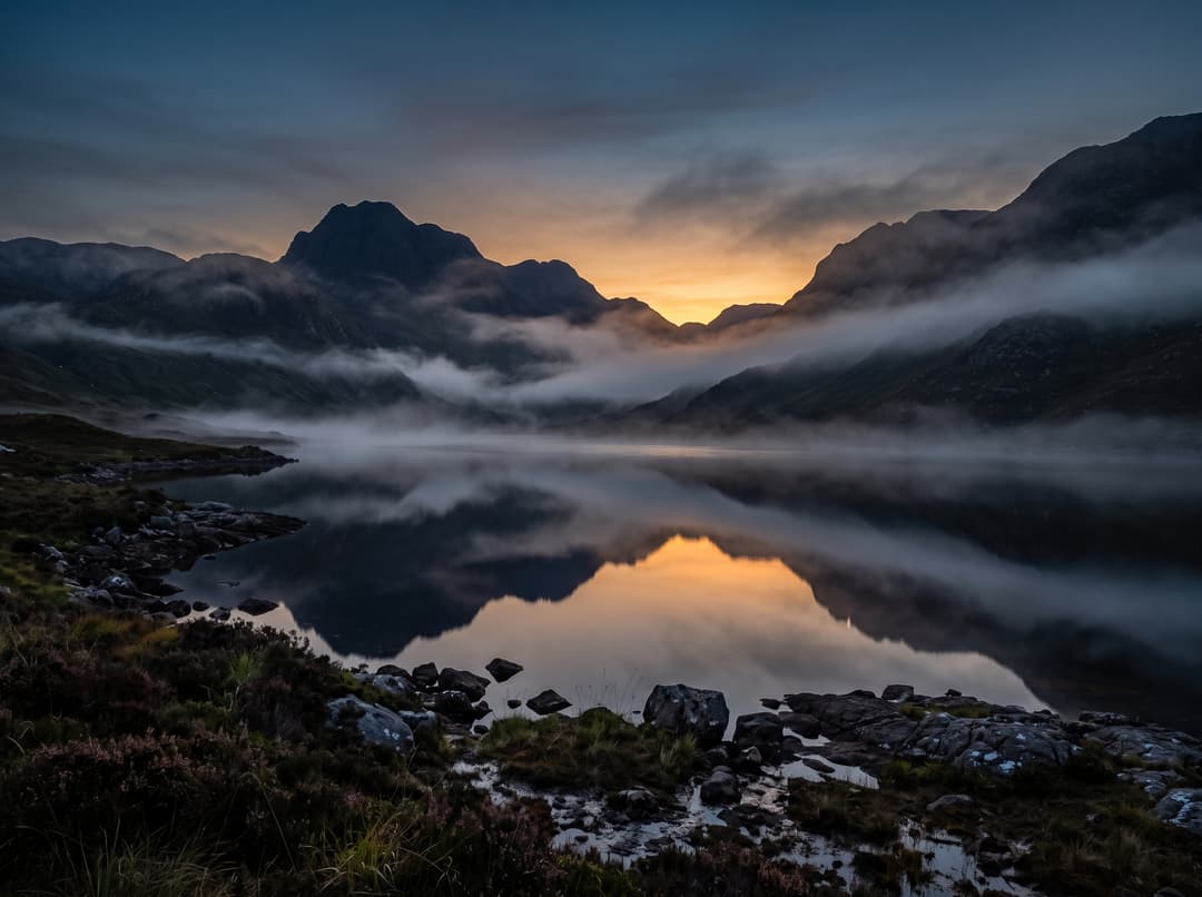 Misty Scottish Highlands loch at dusk