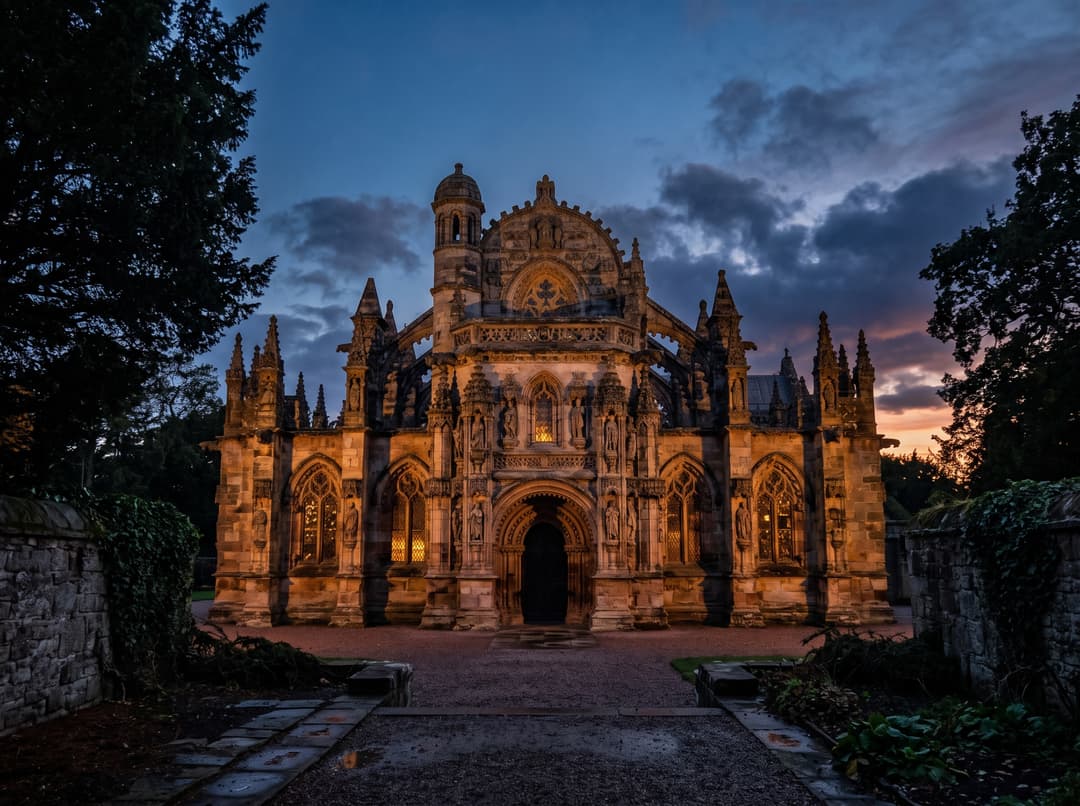 Rosslyn Chapel's ornate gothic facade lit at dusk