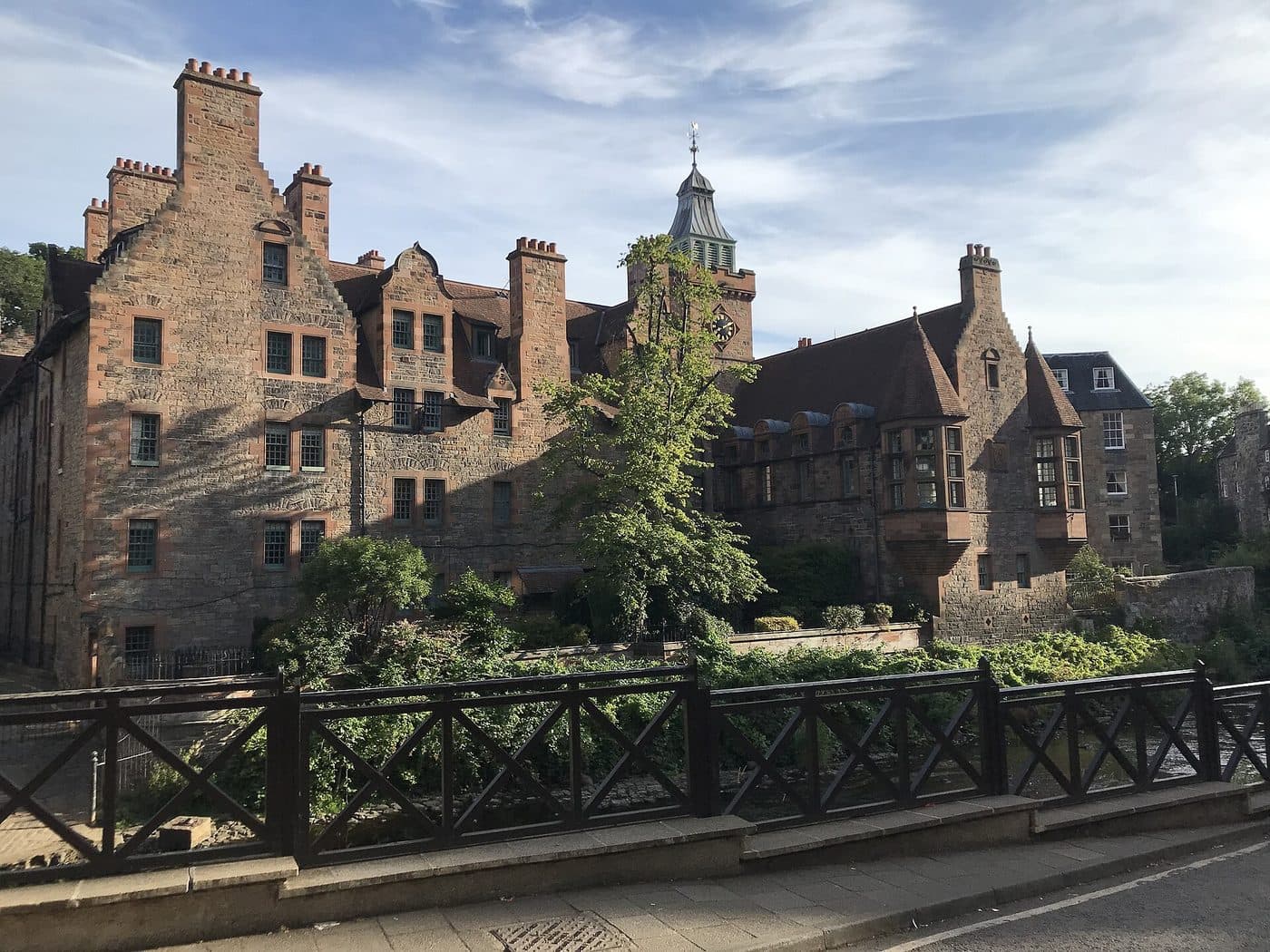 Well Court in Dean Village, Edinburgh, seen from the bridge, with the Water of Leith below and the clock tower behind