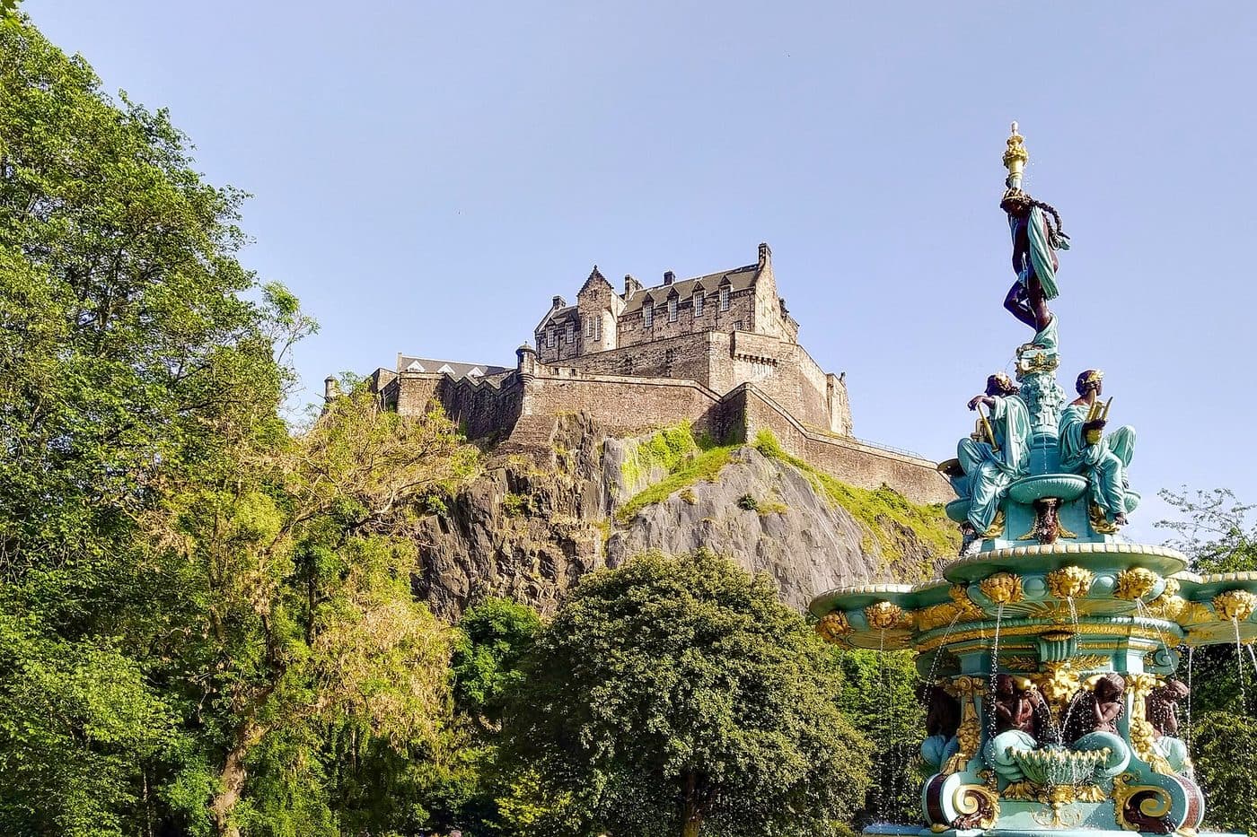The ornate cast-iron Ross Fountain in West Princes Street Gardens with Edinburgh Castle on the rock behind it