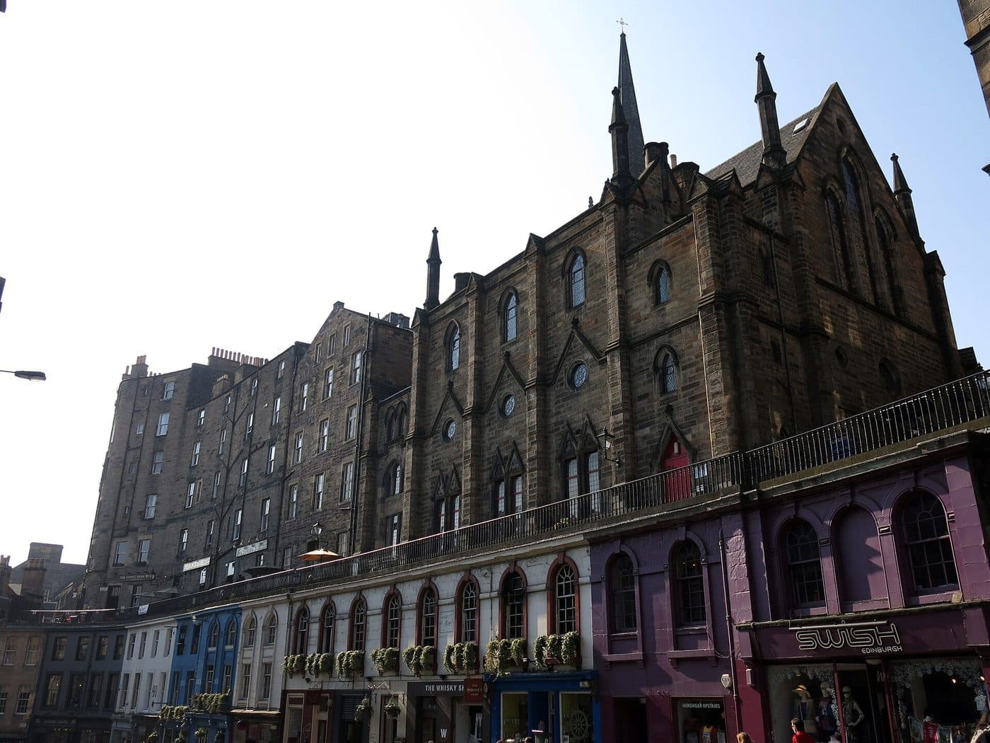 The arcaded shopfronts of Victoria Street with Victoria Terrace and its iron railings running along above them